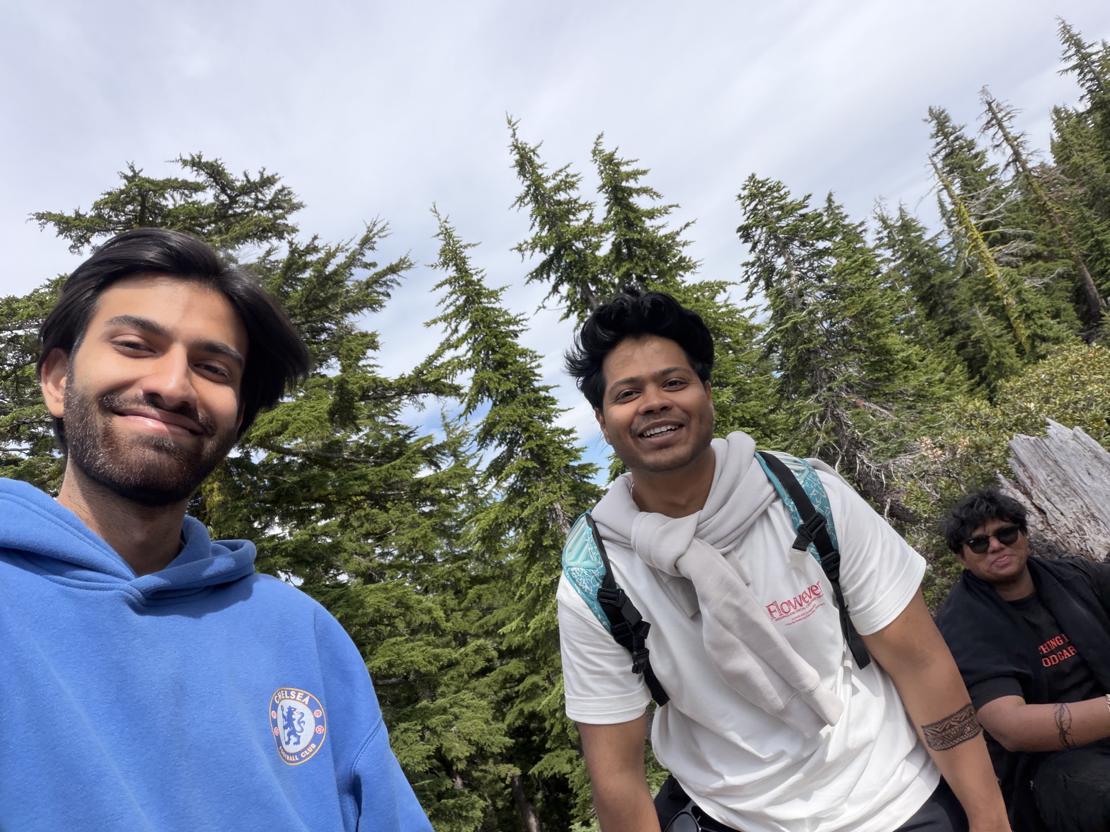 Friends smiling outdoors near trees