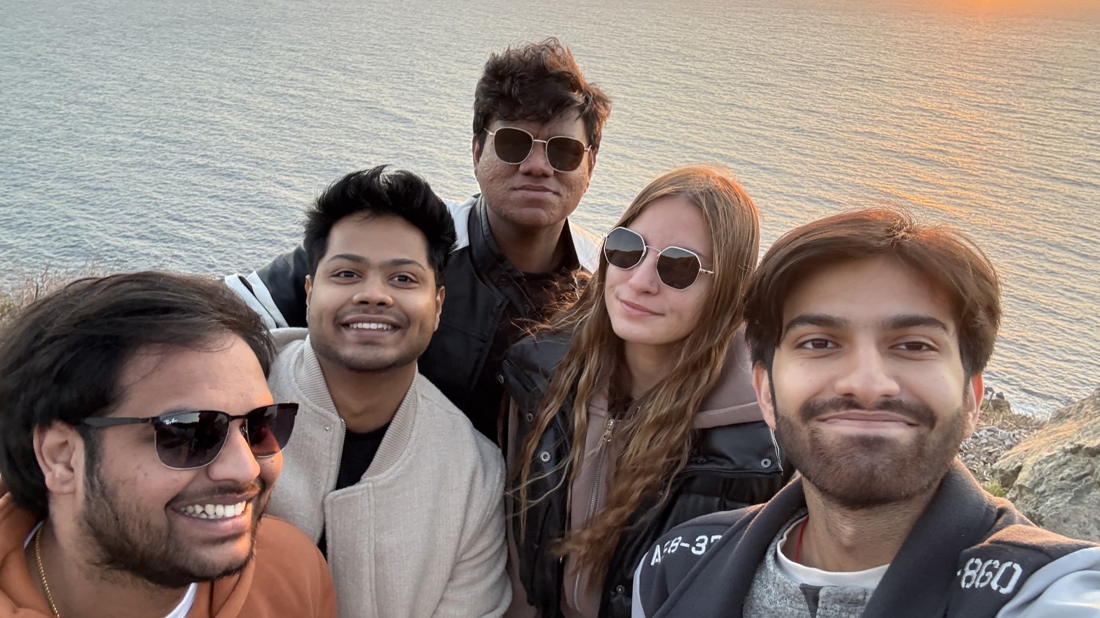 Friends smiling in a seaside selfie